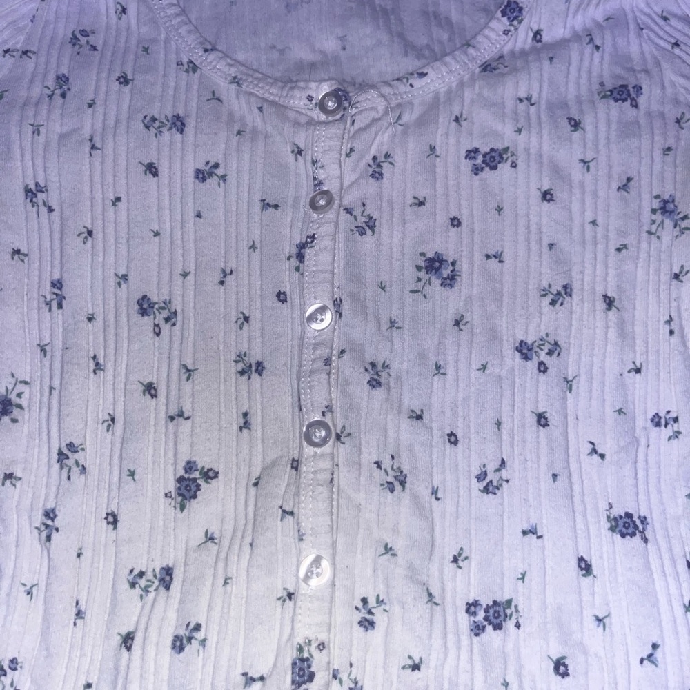 White long-sleeve floral shirt.